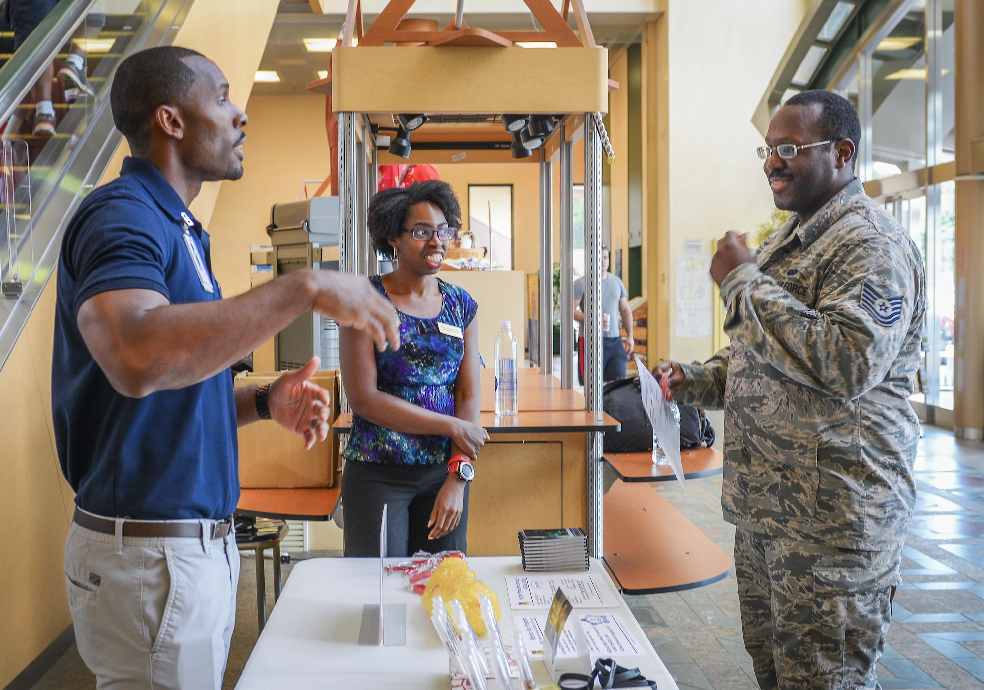 Brandon Waller, 374th Aerospace Medicine Squadron Health Promotion Flight director, educates Yokota Community Center visitors on a variety of common health choices at Yokota Air Base, Japan, Aug. 8, 2016. Waller hopes to use his new position as director to help educate Yokota on how to find an enjoyable path to health and wellness, increasing their mission-readiness and quality of life. (U.S. Air Force Photo by Airman 1st Class Elizabeth Baker/Released)