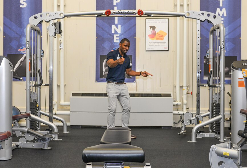 Brandon Waller, 374th Aerospace Medicine Squadron Health Promotion Flight director, poses with fitness equipment at Yokota Air Base, Japan, Aug. 8, 2016. As the new director, Waller hopes to increase Yokota’s physical fitness and mission-readiness by increasing utilization of the Health Promotion Flight’s services and implementing new programs. (U.S. Air Force Photo by Airman 1st Class Elizabeth Baker/Released)