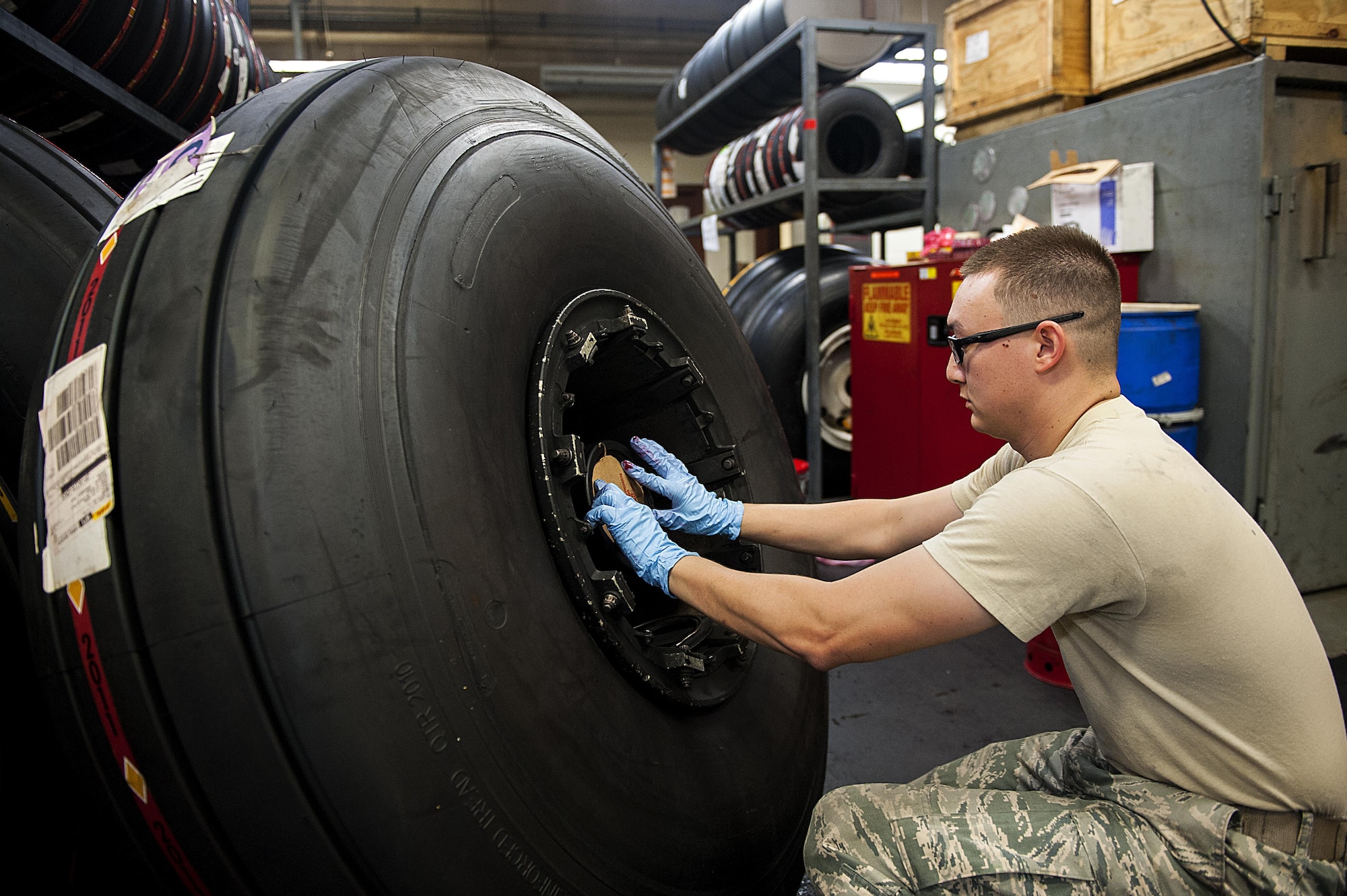 Senior Airman Joel Waller, 18th Equipment Maintenance Squadron wheel and tire technician, finishes building an aircraft tire Aug. 10, 2016, at Kadena Air Base, Japan. The wheel and tire shop breaks down, cleans and re-builds tires that have been taken off of any aircraft stationed here. (U.S. Air Force photo by Airman 1st Class Corey M. Pettis)