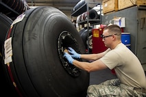 Senior Airman Joel Waller, 18th Equipment Maintenance Squadron wheel and tire technician, finishes building an aircraft tire Aug. 10, 2016, at Kadena Air Base, Japan. The wheel and tire shop breaks down, cleans and re-builds tires that have been taken off of any aircraft stationed here. (U.S. Air Force photo by Airman 1st Class Corey M. Pettis)