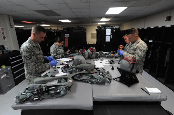 U.S. Air Force Aircrew Flight Equipment technicians assigned to the 509th Operation Support Squadron from Whiteman Air Force Base, Mo., conduct pre-checks on flight equipment at Andersen Air Force Base, Guam, Aug. 9, 2016. The work of the AFE shop ensures the safety of the B-2 pilots and allows the bomber crews to maintain a high state of readiness and proficiency in demonstrating their ability to provide an always-ready global strike capability. (U.S. Air Force photo by Tech. Sgt. Miguel Lara III)