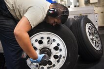 Senior Airman Joshua Shears, 18th Equipment Maintenance Squadron wheel and tire technician, takes apart an aircraft wheel Aug. 10, 2016, at Kadena Air Base, Japan. Aircraft tires must be periodically replaced so the wheel and tire shop takes those wheels, inspects and washes them so they can be used again. (U.S. Air Force photo by Airman 1st Class Corey M. Pettis)
