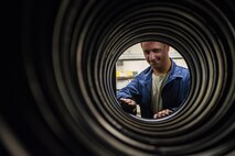 Senior Airman Christopher Tillman, 18th Equipment Maintenance Squadron wheel and tire technician, inspects a row of aircraft tires Aug. 10, 2016, at Kadena Air Base, Japan. The wheel and tire shop picks up old tires and drops off new ones to the different Aircraft Maintenance Units around the base. (U.S. Air Force photo by Airman 1st Class Corey M. Pettis)