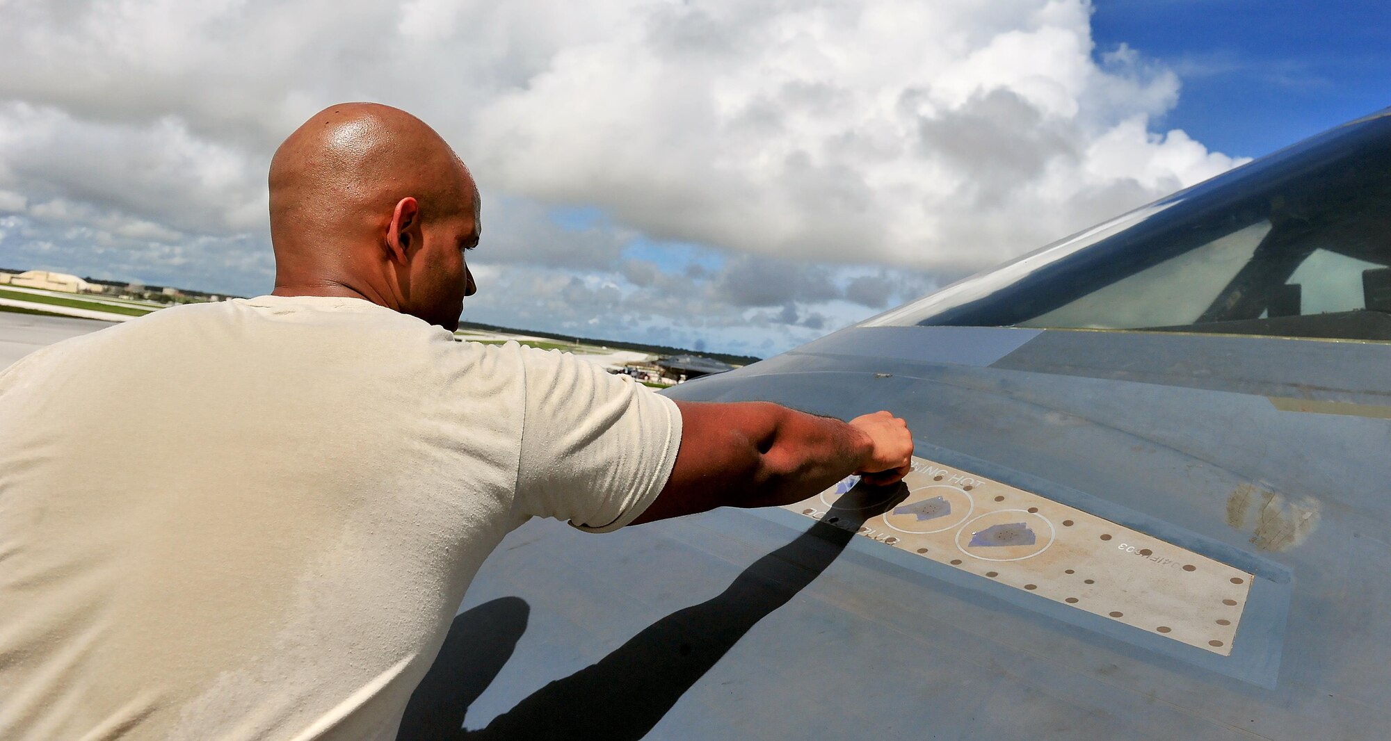U.S. Air Force Senior Airman Julian Tobin, an aerospace repair technician with the 509th Maintenance Squadron, tapes off sections of a B-2 Spirit from Whiteman Air Force Base, Mo., Aug. 10, 216 at Andersen Air Force Base, Guam. The U.S. routinely and visibly demonstrates its commitment to its allies and partners through the global operations of our military forces. (U.S. Air Force photo by Senior Airman Jovan Banks)