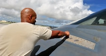 U.S. Air Force Senior Airman Julian Tobin, an aerospace repair technician with the 509th Maintenance Squadron, tapes off sections of a B-2 Spirit from Whiteman Air Force Base, Mo., Aug. 10, 216 at Andersen Air Force Base, Guam. The U.S. routinely and visibly demonstrates its commitment to its allies and partners through the global operations of our military forces. (U.S. Air Force photo by Senior Airman Jovan Banks)