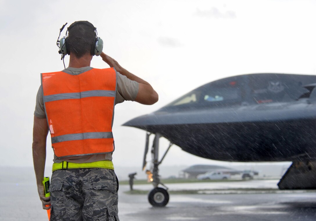 U.S. Air Force Staff Sgt. Matthew Helms, a dedicated crew chief assigned to the 509th Aircraft Maintenance Squadron, salutes a B-2 pilot prior to take off at Andersen Air Force Base, Guam, Aug. 11, 2016. More than 200 Airmen and three B-2s deployed to the Indo-Asia-Pacific region to demonstrate the ability of the U.S. bomber force to provide a flexible and vigilant long-range global strike capability. (U.S. Air Force photo by Tech. Sgt. Miguel Lara III)