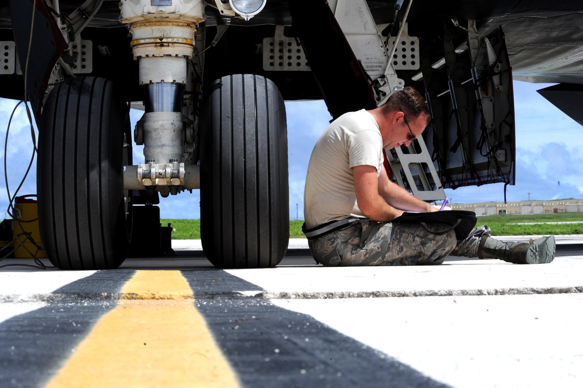 U.S. Air Force Staff Sgt. Kory Stanton, a dedicated crew chief assigned to the 509th Aircraft Maintenance Squadron from Whiteman Air Force Base, Mo., reviews forms during pre-flight checks at Andersen Air Force Base, Guam, Aug. 10, 2016. These bomber missions strengthen capabilities by familiarizing aircrew with airbases and operations across the globe. (U.S. Air Force photo by Tech. Sgt. Miguel Lara III)