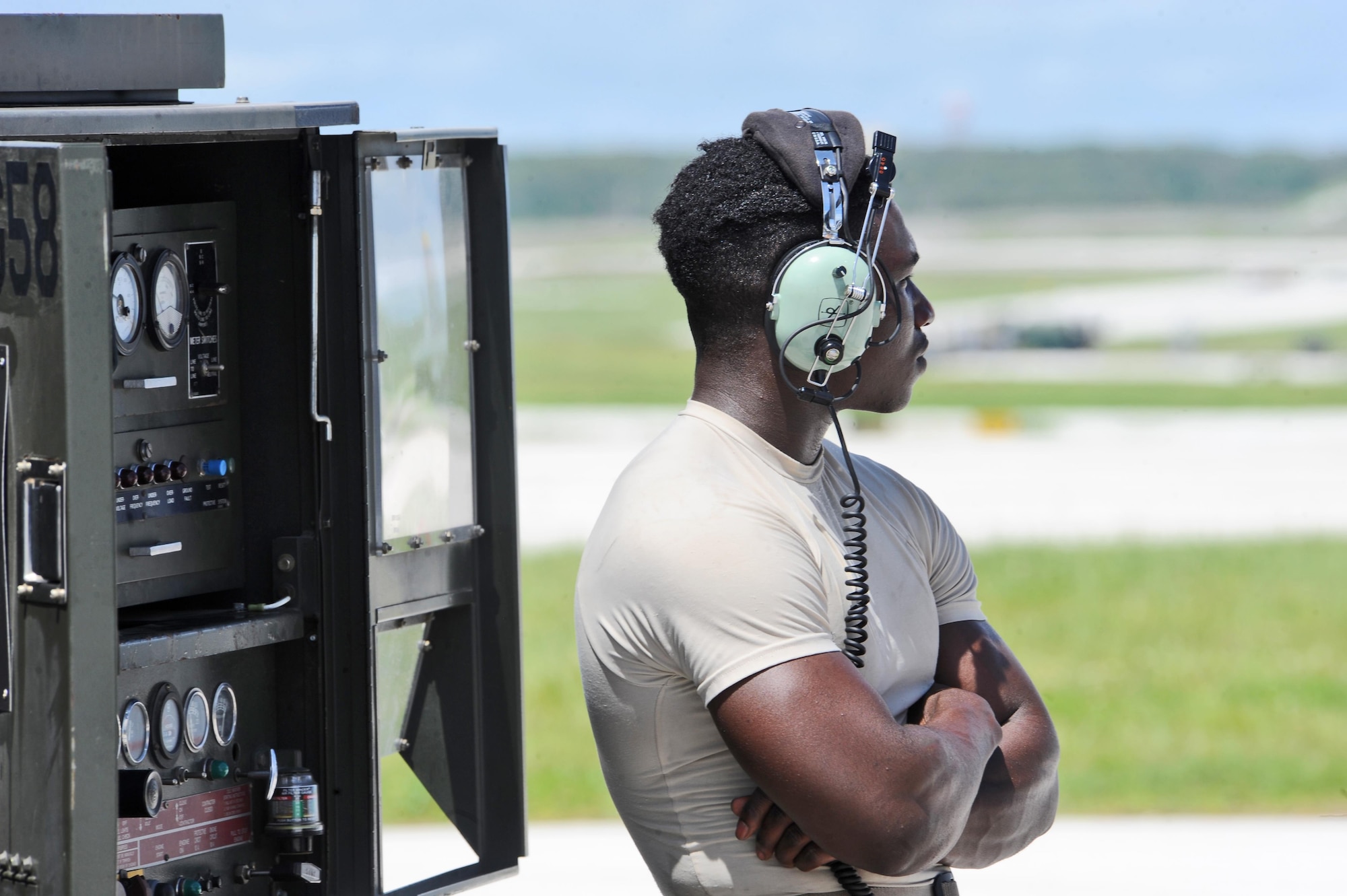 U.S. Air Force Staff Sgt. Elijah Fleming, a crew chief assigned to the 509th Aircraft Maintenance Squadron from Whiteman Air Force Base, Mo., waits for communication near a generator during pre-flight checks at Andersen Air Force Base, Guam, Aug. 10, 2016. Bomber training missions ensure crews maintain a high state of readiness and proficiency and demonstrate their ability to provide an always-ready global strike capability. (U.S. Air Force photo by Tech. Sgt. Miguel Lara III)