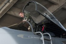 Capt. Benjamin Worrall, 67th Fighter Squadron operations flight commander, climbs into the cockpit of an F-15 Eagle Aug. 9, 2016, at Kadena Air Base, Japan. Worrall conducted a training flight to test his offensive basic fighter maneuvering as part of his training in becoming an instructor pilot. (U.S. Air Force photo by Airman 1st Class Lynette M. Rolen)
