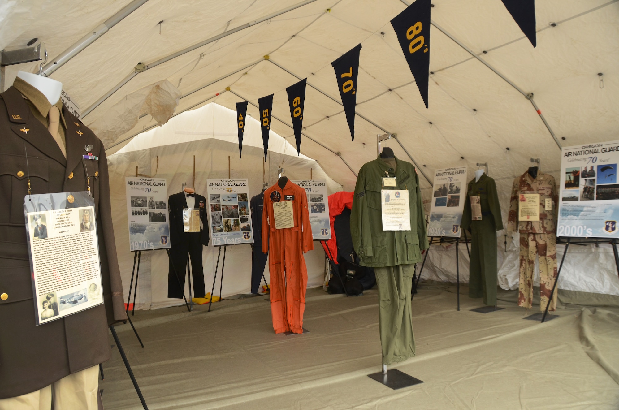 A military tent from the 142nd Fighter Wing helps display historical uniforms and photographs to celebrate the 75th Anniversary of the Oregon Air National Guard, Hillsboro, Ore., Aug. 7, 2016. (U.S. Air National Guard photo by Tech. Sgt. John Hughel, 142nd Fighter Wing Public Affairs/Released).