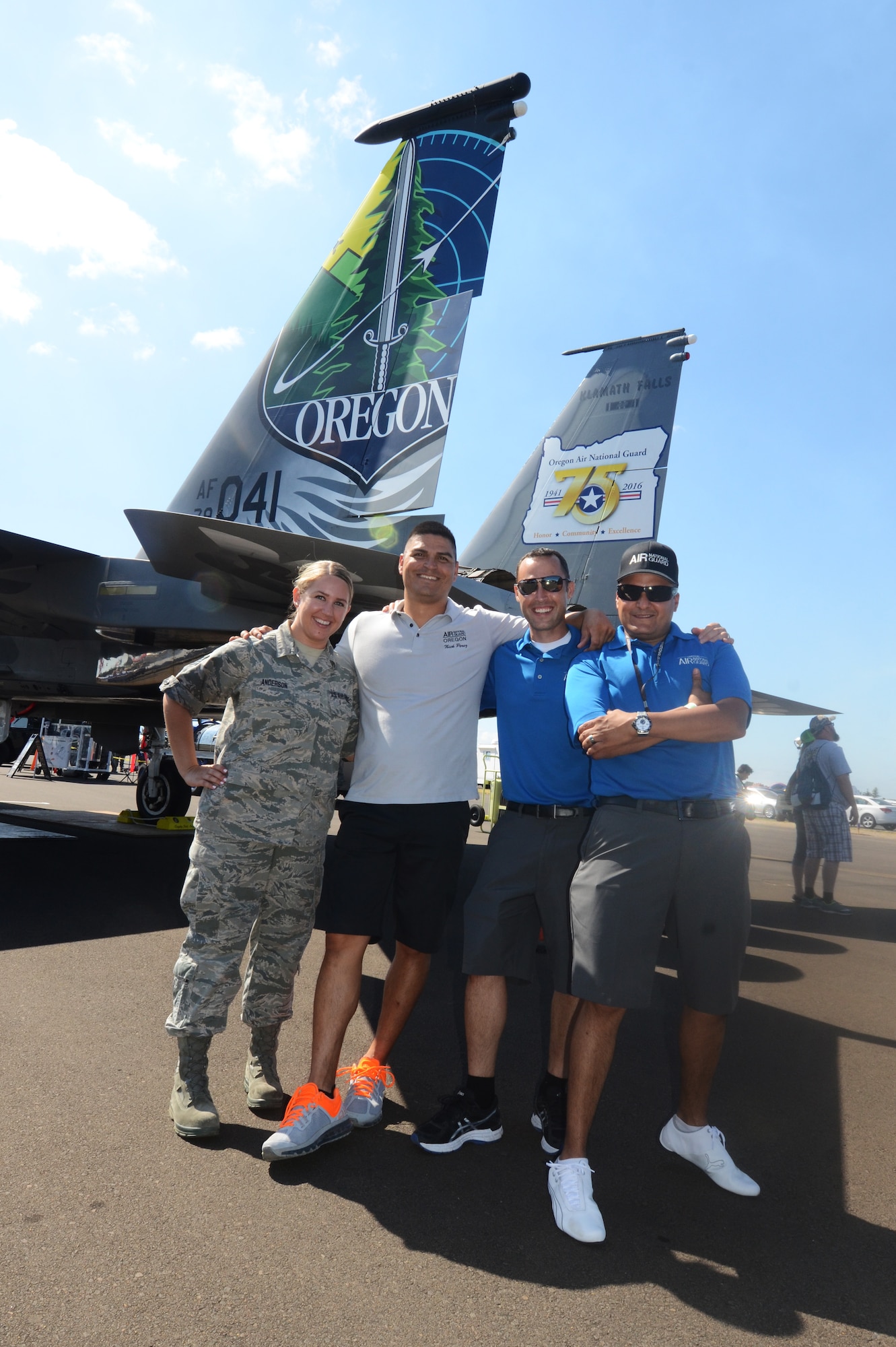 Oregon Air National Guard Recruiters pause for a photo with an F-15 Eagle during the Oregon International Air Show, Hillsboro International Airport, Aug. 6, 2016. (U.S. Air National Guard photo by Tech. Sgt. John Hughel, 142nd Fighter Wing Public Affairs/Released).