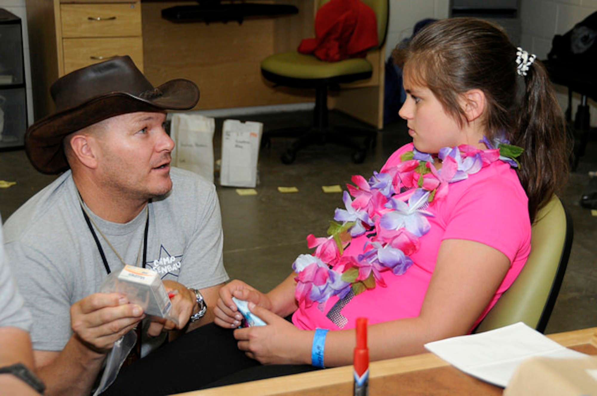 Capt. Randy Schumacher, a Camp Rosenbaum medic who also serves as a nurse at the Portland Air National Guard Base, explains medication to a camper. Schumacher has volunteered at Camp Rosenbaum for six years. (U.S. Air Force photo by Tech. Sgt. Emily Thompson)