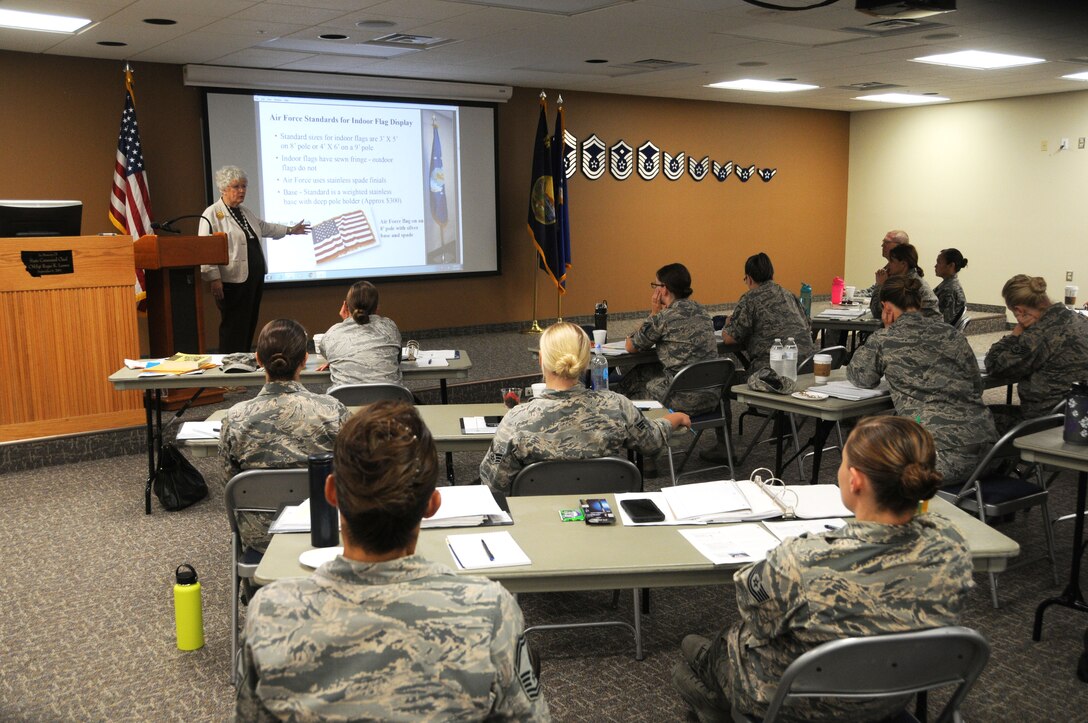 Maggie Bonner teaches flag etiquette to members of the 120th Airlift Wing in the Larsen Room of the 120AW Headquarters Building July 27, 2016. Bonner was teaching a protocol class for the Montana Air National Guard Airmen. (U.S. Air National Guard photo by Senior Master Sgt. Eric Peterson)