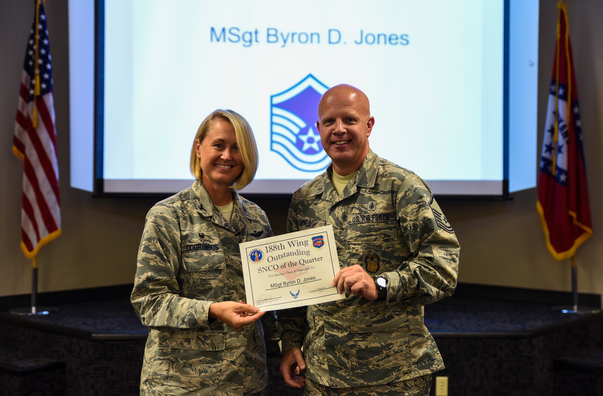 Master Sgt. Byron Jones, 188th Wing Staff administrator, is named the 188th Outstanding Senior Noncommissioned Officer of the Quarter Aug. 6, 2016, for fiscal year 2016 quarter three at Ebbing Air National Guard Base, Fort Smith, Ark. The Outstanding Airman of the Quarter program promotes professional development, innovation and mission success by recognizing those who excel in their carrier fields while fostering the cultivation of ready, responsive and highly-skilled Airman. The award was presented to Overstreet by Col. Bobbi Doorenbos, 188th Wing commander. (U.S. Air National Guard photo by Senior Airman Cody Martin)