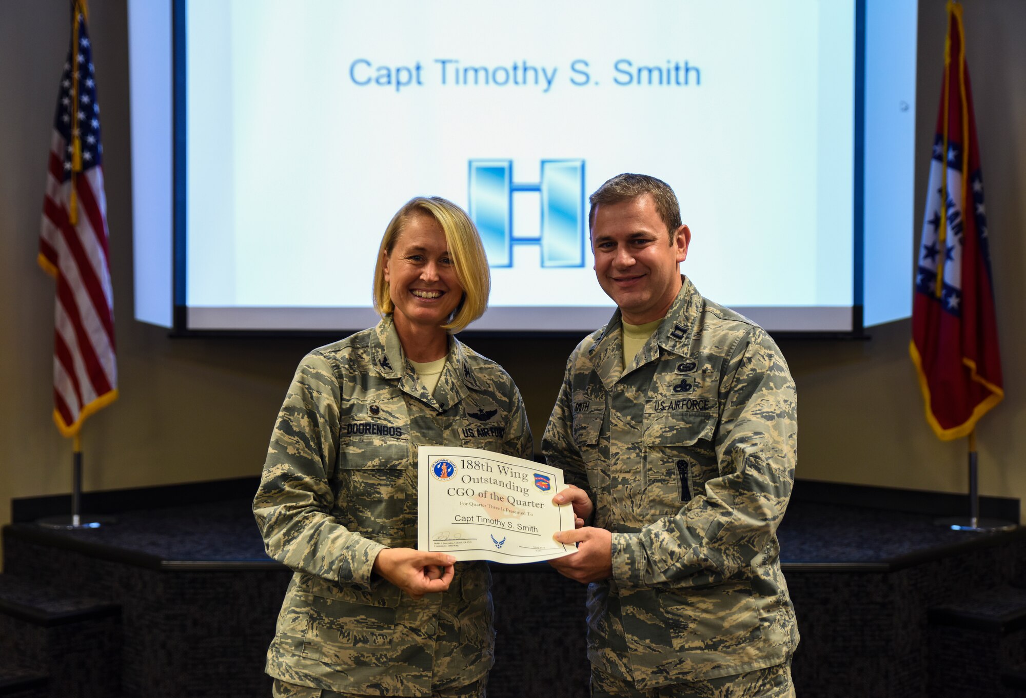 Capt. Timothy Smith, 123rd Intelligence Squadron, is named the 188th Outstanding Company Grade Officer of the Quarter Aug. 6, 2016, for fiscal year 2016 quarter three at Ebbing Air National Guard Base, Fort Smith, Ark. The Outstanding Airman of the Quarter program promotes professional development, innovation and mission success by recognizing those who excel in their carrier fields while fostering the cultivation of ready, responsive and highly-skilled Airman. The award was presented to Overstreet by Col. Bobbi Doorenbos, 188th Wing commander. (U.S. Air National Guard photo by Senior Airman Cody Martin)