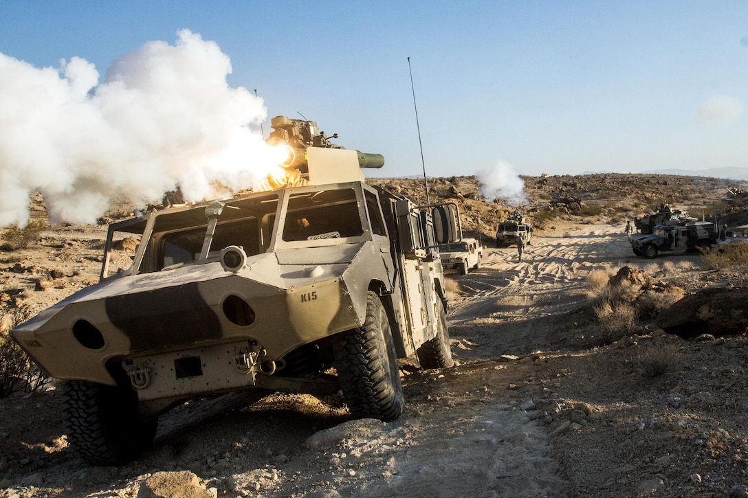 Soldiers in a vehicle defend their position while firing a simulated tube-launched, optically tracked missile at an M1A1 Abrams battle tank in the distance at the National Training Center at Fort Irwin, Calif., Aug. 3, 2016. The exercise tested the unit's ability to conduct defensive operations while defending their operations center. The vehicle is assigned to  Killer Troop, 2nd Squadron, 11th Armored Cavalry Regiment. Army photo by Pvt. Austin Anyzeski