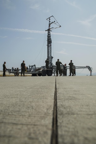 U.S. Marines with Aircraft Recovery assigned to Headquarters and Headquarters Squadron, prepare the mobile Expeditionary Hover Position Indicator for use on the helicopter runway at Marine Corps Air Station Iwakuni, Japan, Aug. 9, 2016. The aircraft recovery Marines worked to set up the mobile EHPI to provide pilots from Marine Attack Squadron (VMA) 542 an opportunity to recertify in boat-deck landings before departing for other future operations in the Pacific. Home based out of Marine Corps Air Station Cherry Point, N.C., VMA-542 is forward deployed as part of the unit deployment program at MCAS Iwakuni and is strengthening their aviation operational skills with the station’s units while abroad. (U.S. Marine Corps photo by Lance Cpl. Donato Maffin)