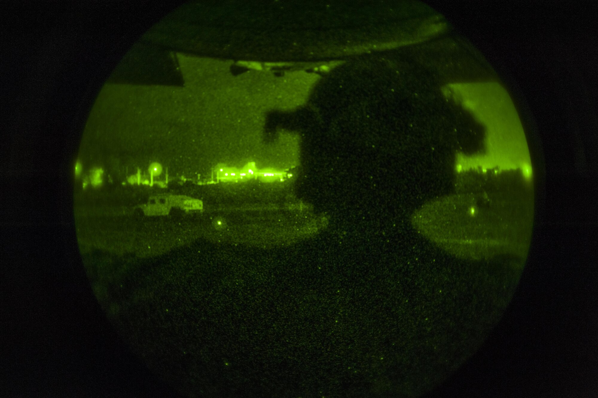 A member of the 1st Special Operations Support Squadron watches as members of the deployed aircraft ground response element conduct a training exercise on the flightline at Kadena Air Base, Okinawa, Japan on Aug. 10, 2016. The DAGRE Airmen are a group of highly trained Security Forces personnel who support Special Operations Command assets and resources worldwide. (U.S. Air Force Photo by Airman 1st Class Nick Emerick)