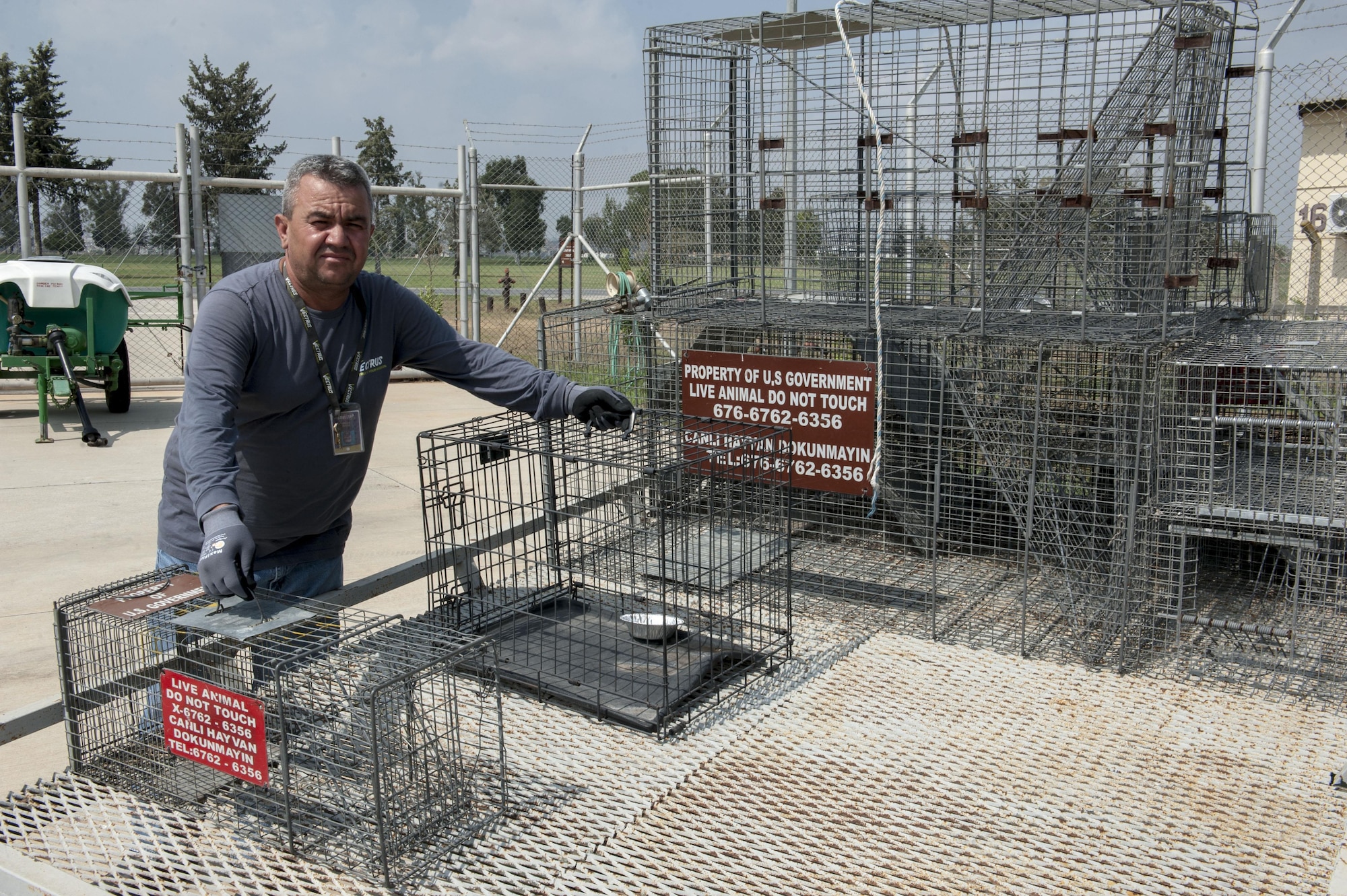 Mehmet Turkmen 39th Civil Engineer Squadron pest management animal handler stands next to live capture traps on the back of a trailer in the pest management yard Aug. 11, 2016, at Incirlik Air Base, Turkey. Members of the pest management flight are responsible for the safe capture and removal of problematic wild animals from the installation. (U.S. Air Force photo by Staff Sgt. Jack Sanders)