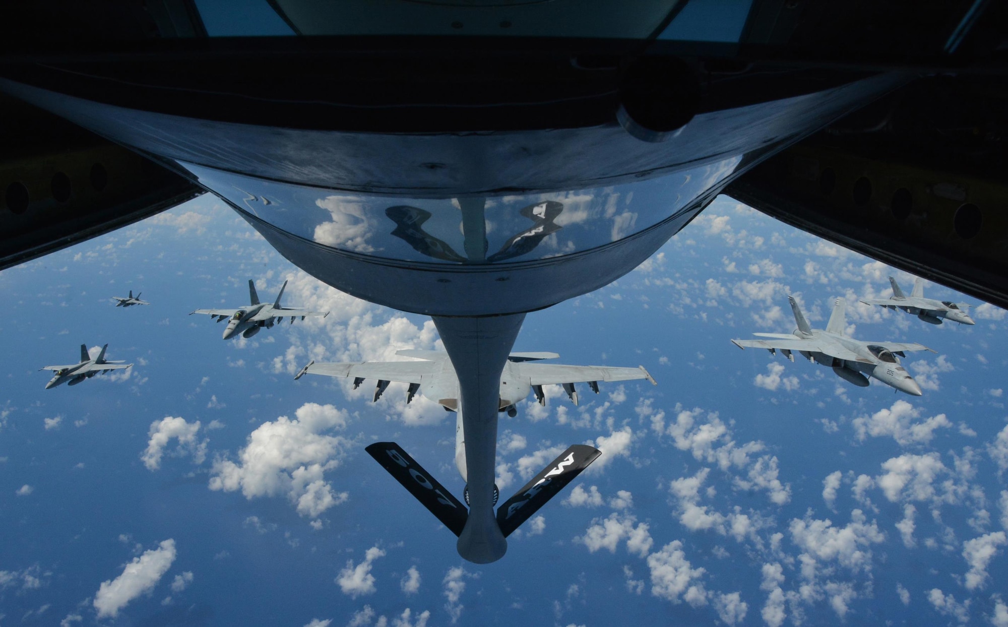 160720-F-EW270-248 JOINT BASE PEARL HARBOR-HICKAM (July 20, 2016) Six U.S. Navy F-18 Hornets await refueling from a KC-135R Stratotanker belonging to the 507th Air Refueling Wing at Tinker Air Force Base, Okla., during Rim of the Pacific 2016. Twenty-six nations, more than 40 ships and submarines, more than 200 aircraft, and 25,000 personnel are participating in RIMPAC from June 30 to Aug. 4, in and around the Hawaiian Islands and Southern California. The world's largest international maritime exercise, RIMPAC provides a unique training opportunity that helps participants foster and sustain the cooperative relationships that are critical to ensuring the safety of sea lanes and security on the world's oceans. RIMPAC 2016 is the 25th exercise in the series that began in 1971. (U.S. Air Force photo by Tech. Sgt. Lauren Gleason)