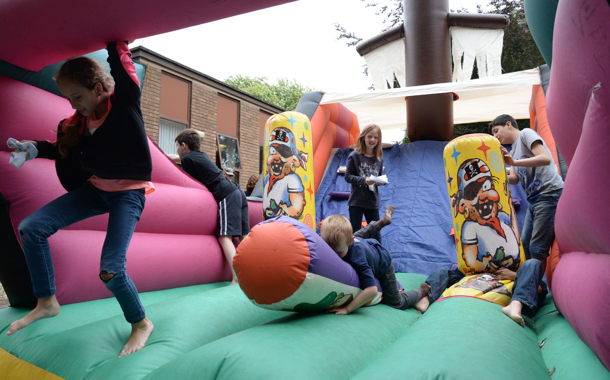 Family members of deployed Airmen jump on a bounce house at the Hearts Apart event, hosted by the 351st Air Refueling Squadron, at the base chapel on RAF Mildenhall, England. The event’s intent is to bring together and show support for families of deployed military members. (U.S. Air Force photo by Senior Airman Justine Rho)