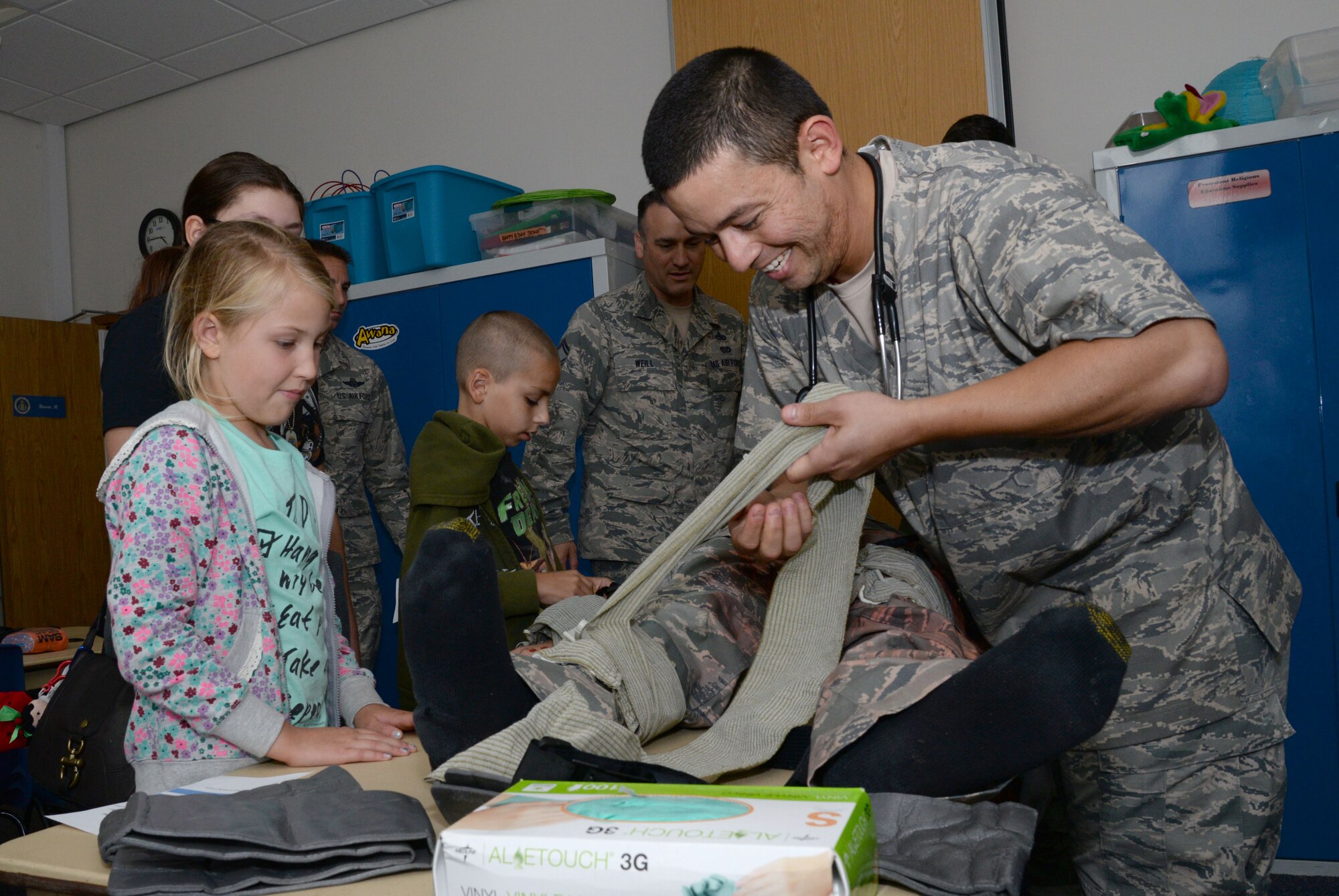 Guests of the Hearts Apart event, hosted by the 351st Air Refueling Squadron, are given hands on self-aid buddy care training Aug. 12, 2016, at the base chapel on RAF Mildenhall, England. The event is held monthly to bring families of deployed military members together to participate in dinner and activities. (U.S. Air Force photo by Senior Airman Justine Rho)