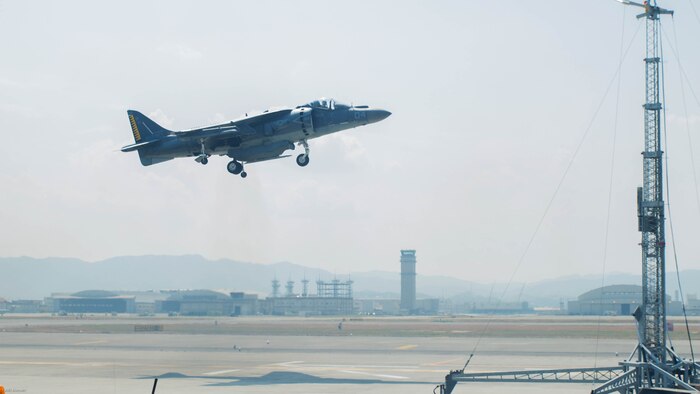 A U.S. Marine Corps AV-8B Harrier with Marine Attack Squadron 542 performs a vertical landing while using the lights on the mobile Expeditionary Hover Position Indicator to adjust its position at Marine Corps Air Station Iwakuni, Japan, Aug. 9, 2016. VMA-542 is home based out of Marine Corps Air Station Cherry Point, N.C., and is forward deployed to MCAS Iwakuni, Japan, as part of the unit deployment program. The Harrier pilots used the mobile EHPI in coordination with Aircraft Recovery assigned to Headquarters and Headquarters Squadron to recertify on boat-deck landings to prepare for other future operations in the Pacific. 