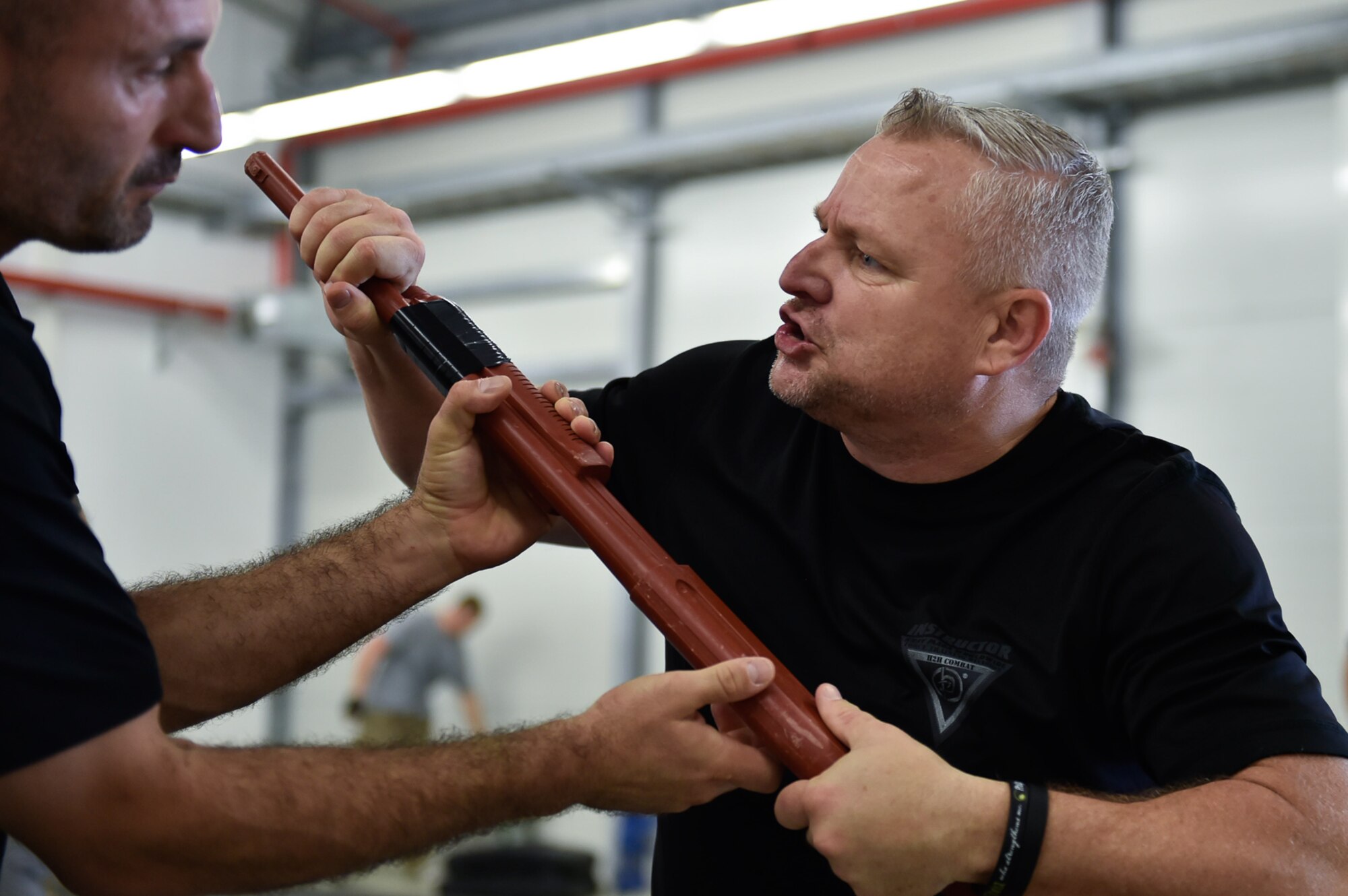 Michael Davis, a Krav Maga instructor, pulls a weapon out of his assaulter’s hands August 4, 2016, at Ramstein Air Base, Germany. Davis and other instructors displayed the correct way to perform the techniques they were teaching. (U.S. Air Force photo/Airman 1st Class Savannah L. Waters)

