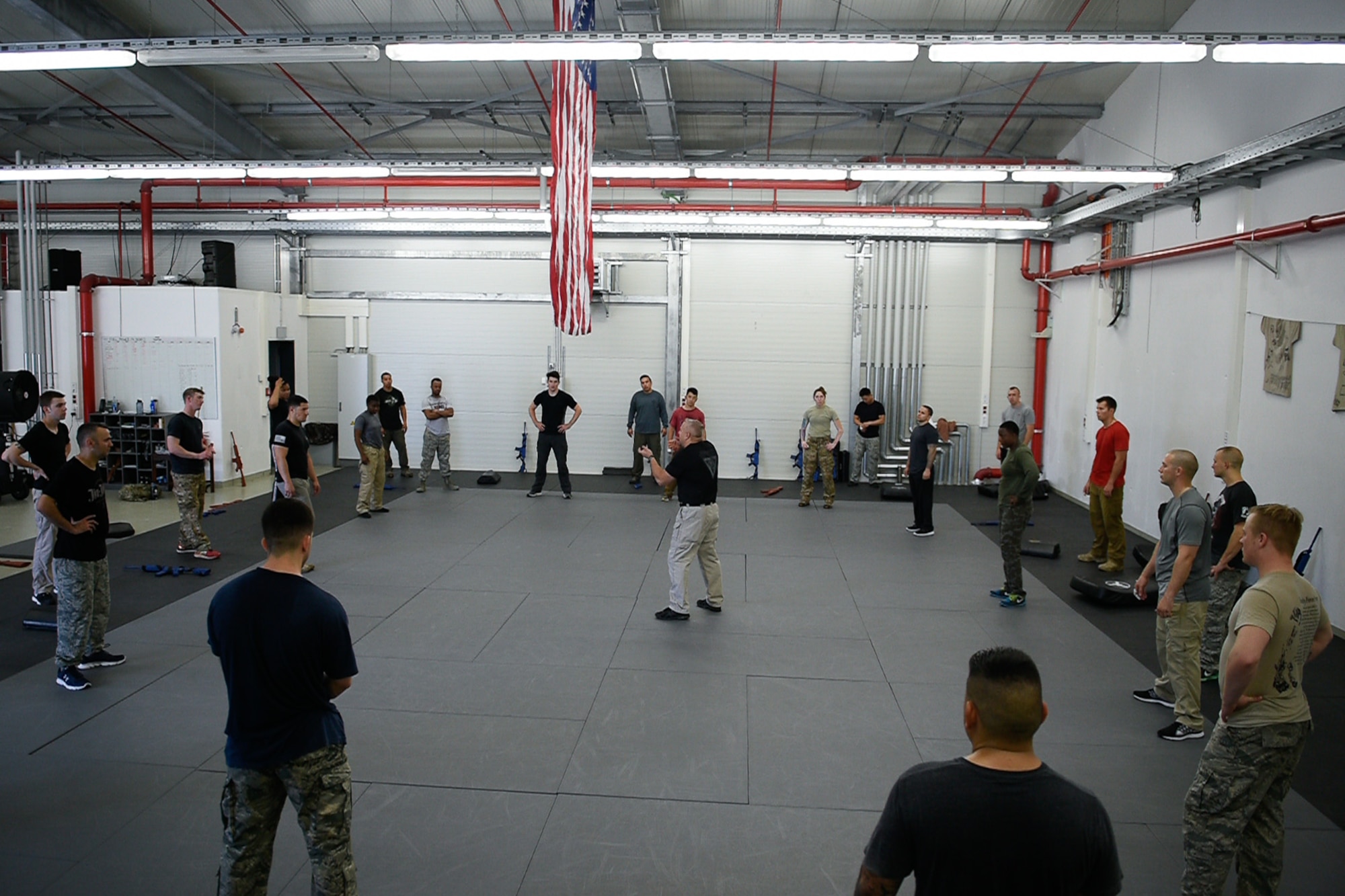 Participants of the Krav Maga course gather around their instructor August 4, 2016, at Ramstein Air Base, Germany. At the end of the training day, students tested their new skills as a class. (U.S. Air Force photo/Airman 1st Class Savannah L. Waters)