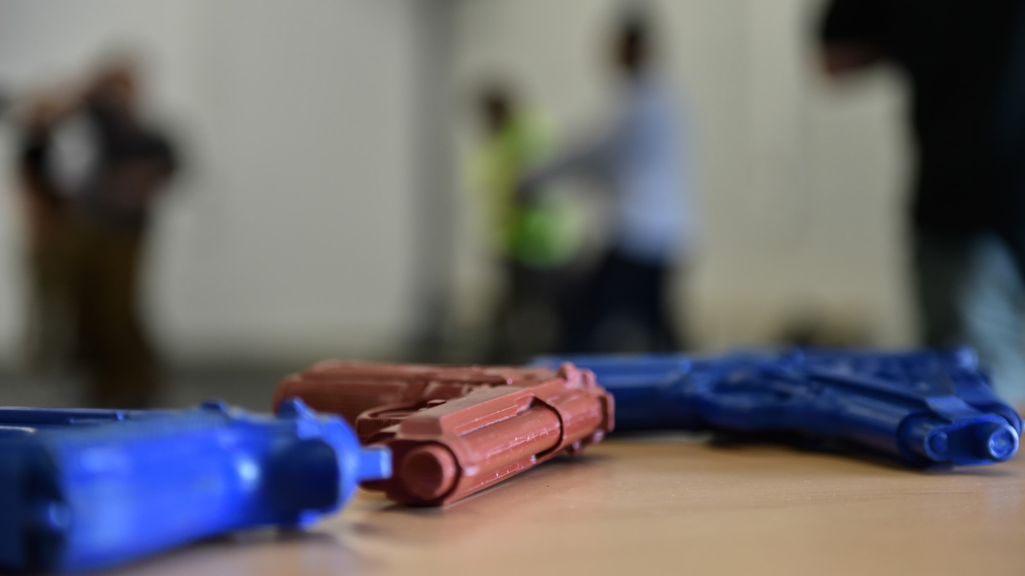 Students practice their exercises behind a table with mock weapons August 5, 2016, at Ramstein Air Base, Germany. The week-long course was made from a basic self-defense system of redirecting, controlling, attacking, and taking away from a situation. (U.S. Air Force photo/Airman 1st Class Savannah L. Waters)