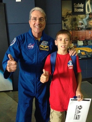 Conner Mullins pauses for a picture with NASA astronaut Don Thomas at Space Camp graduation at the U.S. Space & Rocket Center. 

