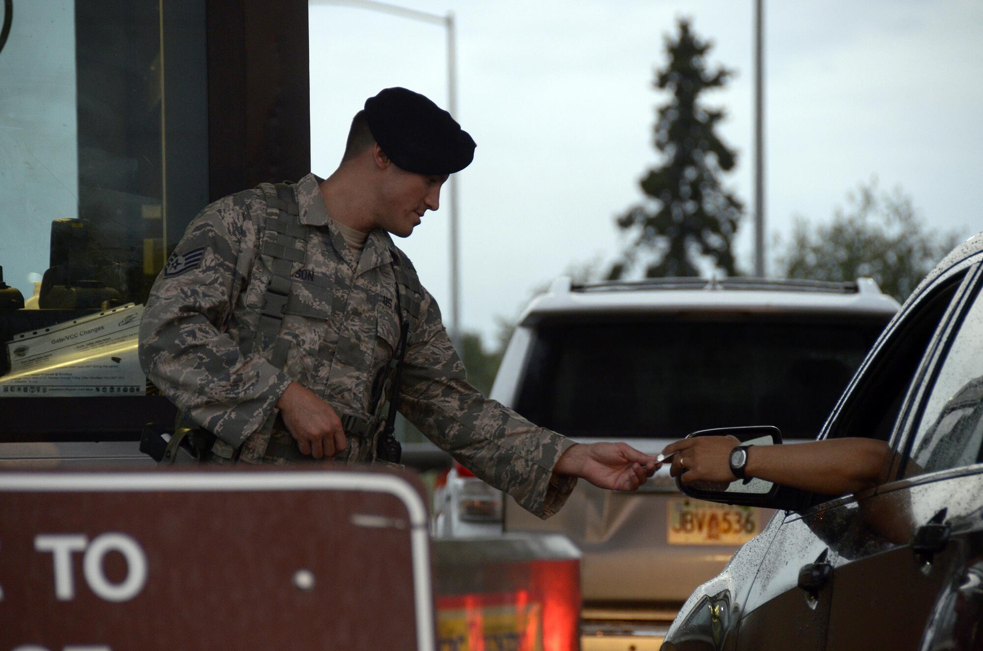 JOINT BASE ELMENDORF-RICHARDSON, Alaska – Staff Sgt. Dustin Ellison, a defender with the 445th Security Forces Squadron, Wright-Patterson Air Force Base, Ohio, checks the identification card of an individual passing through an entry point here July 25, 2016. Reservists from the 445th SFS worked alongside the 673rd Security Forces Squadron during their annual tour. (U.S. Air Force photo/Staff Sgt. Joel McCullough)