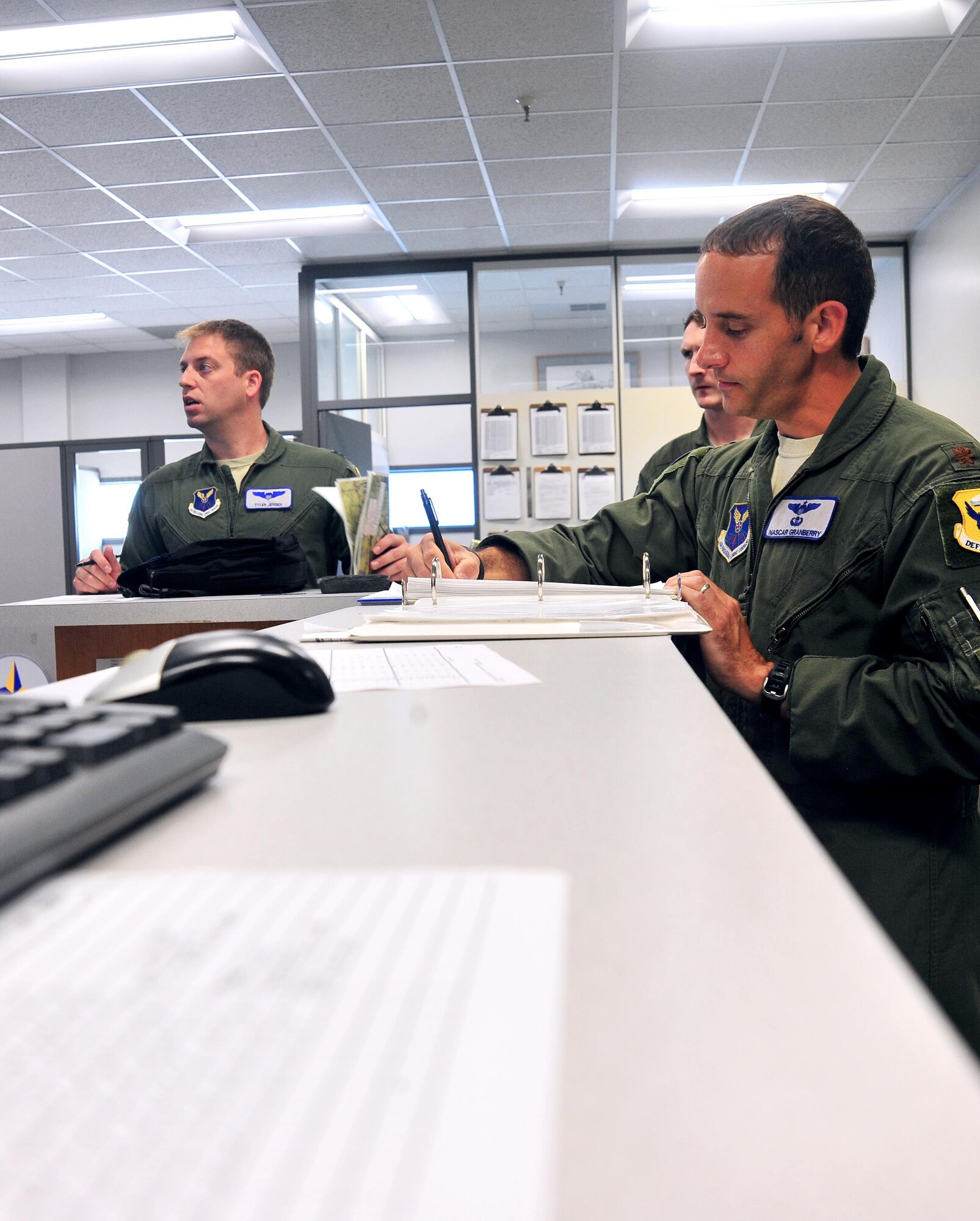 U.S. Air Force Maj. Michael Granberry, the 394th Combat Training Squadron T-38 Talon assisted director of operations of the Companion Trainer Program (CTP), signs off pre-flight requirements before piloting a T-38 Talon Aircraft at Whiteman Air Force Base, July 12, 2016. Pilots undergo a flight briefing that includes a weather report and other aircraft in airspace before flying.
