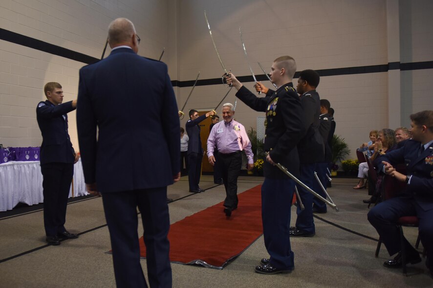 Purple Heart recipients walk through a saber cordon during a Purple Heart dinner, Aug. 5, 2016, in Goldsboro, North Carolina. A total of 76 Purple Heart recipients were honored during the event. (U.S. Air Force photo/Airman 1st Class Ashley Williamson)
