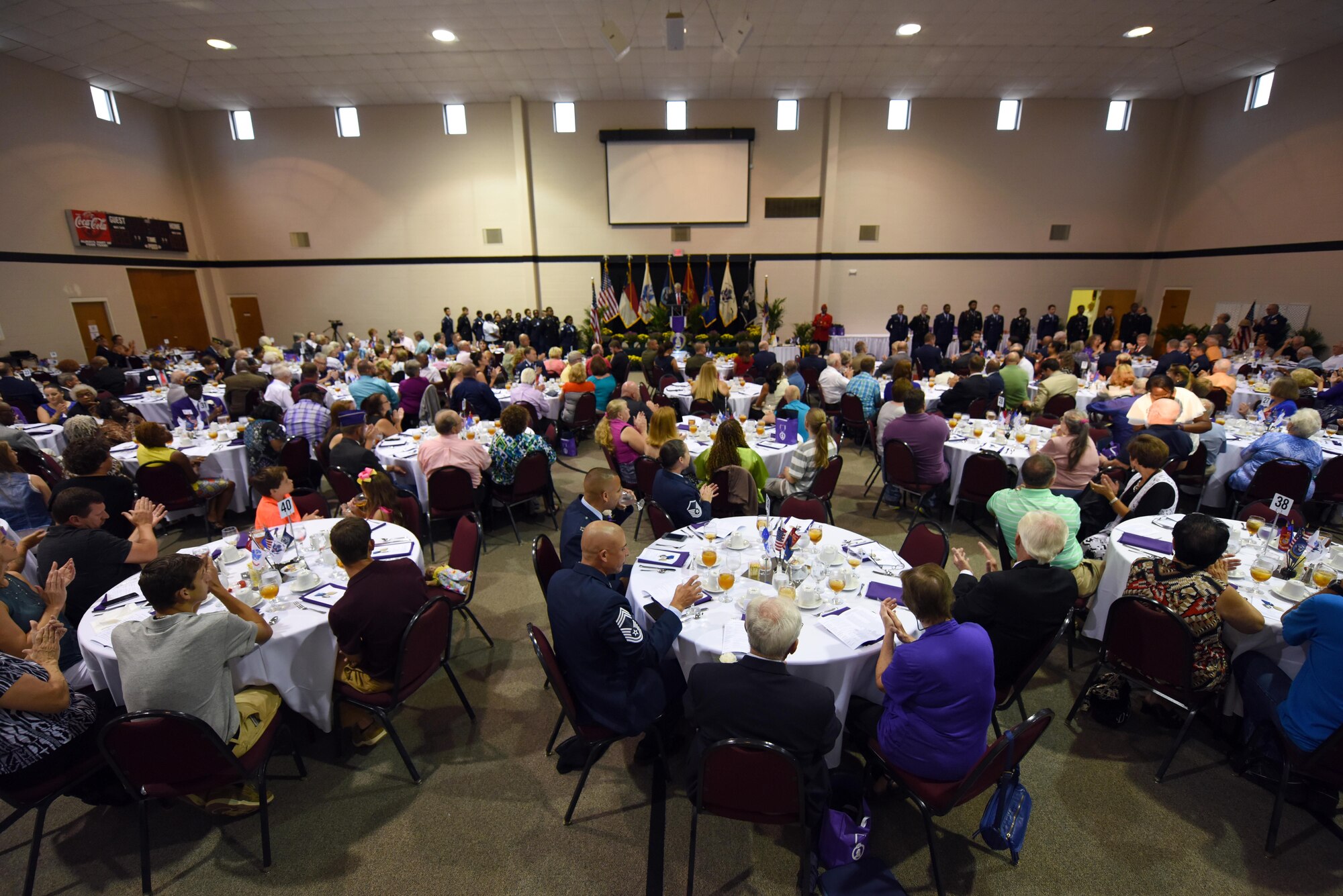 Service members, family and friends gather to recognize local Purple Heart recipients and their sacrifice during a banquet, Aug. 5, 2016, in Goldsboro, North Carolina. Volunteers from Seymour Johnson Air Force Base, N.C. set up, served dinner and disassembled the event. (U.S. Air Force photo/Airman 1st Class Ashley Williamson)