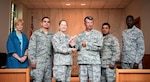 Members of the 59th Medical Wing Chaplain Office gather in the Wilford Hall Ambulatory Surgical Center chapel for a group photo after receiving the Air Education and Training Command’s Robert P. Taylor Award for best small chapel team Aug. 9. The team includes, from left, Nancy Authier, Senior Airman Victor Walker, Maj. (Ch.) Heather Bodwell, Lt. Col. (Ch.) Gary Bertsch, Maj. (Ch.) Raju Thottankara, and Senior Airman Marc Allen. (Air Force photo/Staff Sgt. Jerilyn Quintanilla)