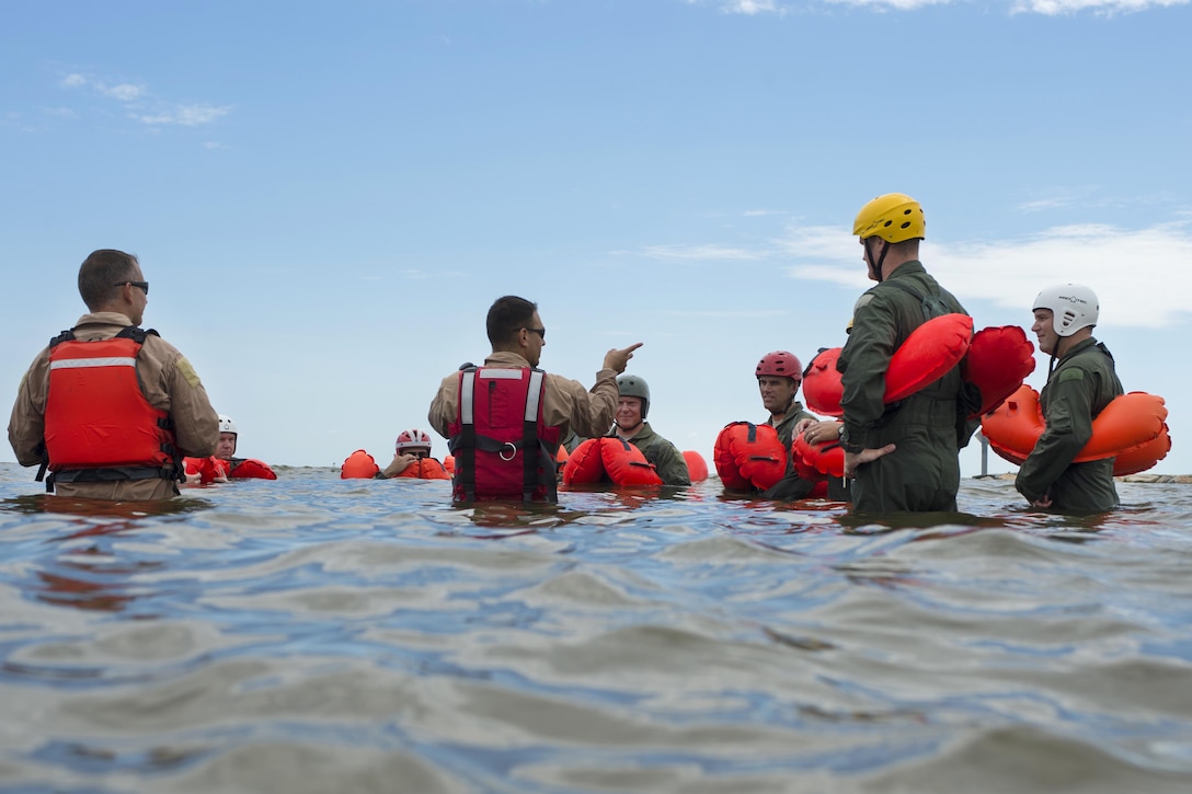 Air Force Tech. Sgt. Joseph Monreal, center, gives instruction on different water-treading techniques to airmen during water survival training at Bowers Beach, Del., Aug. 6, 2016. Monreal is assigned to the 436th Operations Support Squadron. Air Force photo by Tech. Sgt. Nathan Rivard