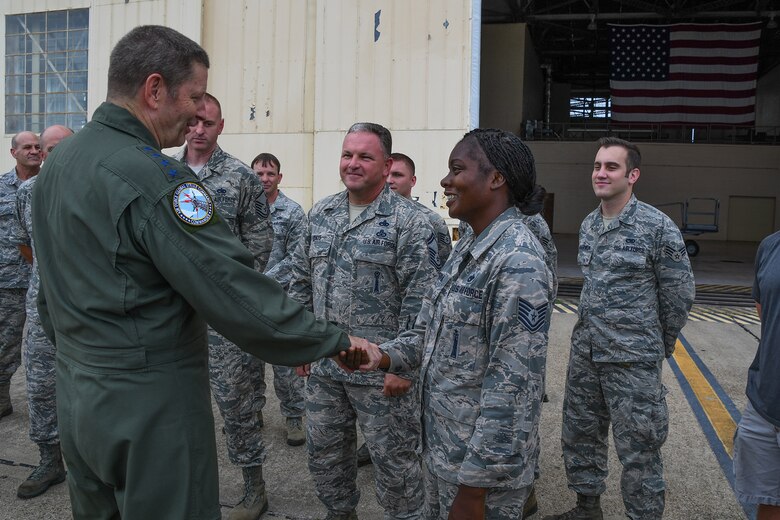 Gen. Robin Rand, AFGSC commander, presents Tech Sgt. Holly Guerra of the 307th Aircraft Maintenance Squadron a coin on Barksdale Air Force Base, La., August 8, 2016. Guerra received the coin in recognition for being a superior performer in her squadron. (U.S. Air Force photo by Master Sgt. Dachelle Melville)