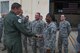 Gen. Robin Rand, AFGSC commander, presents Tech Sgt. Holly Guerra of the 307th Aircraft Maintenance Squadron a coin on Barksdale Air Force Base, La., August 8, 2016. Guerra received the coin in recognition for being a superior performer in her squadron. (U.S. Air Force photo by Master Sgt. Dachelle Melville)