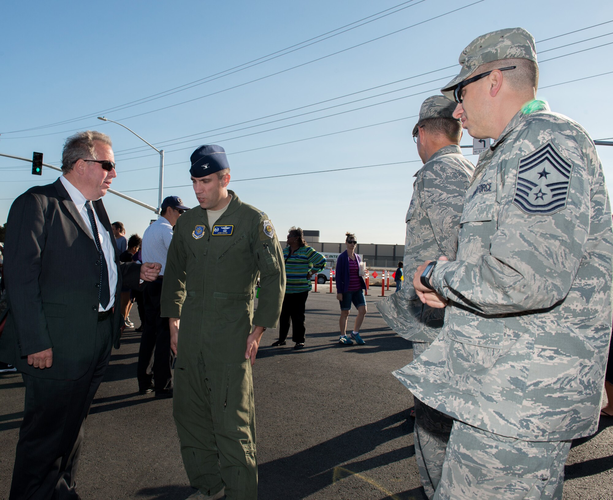 U.S. Air Force Col. John Klein, 60th Air Mobility Wing commander, at Travis Air Force Base, Calif., speaks with assembly member Bill Dodd, 4th District Calif., before the Peabody Road reopening ceremony in Fairfield, Calif., Aug. 4, 2016. The road was closed for 14-months and finished ten days ahead of schedule. Peabody Road is a major thoroughfare that connects the cities of Vacaville and Fairfield, more than 20,000 vehicles per day use the road and it is also a major artery into Travis Air Force Base for more than 14,000 employees. The construction of the Peabody Road overpass is part of the new Fairfield-Vacaville train station project along the Capitol Corridor. (U.S. Air Force photo by Louis Briscese) 