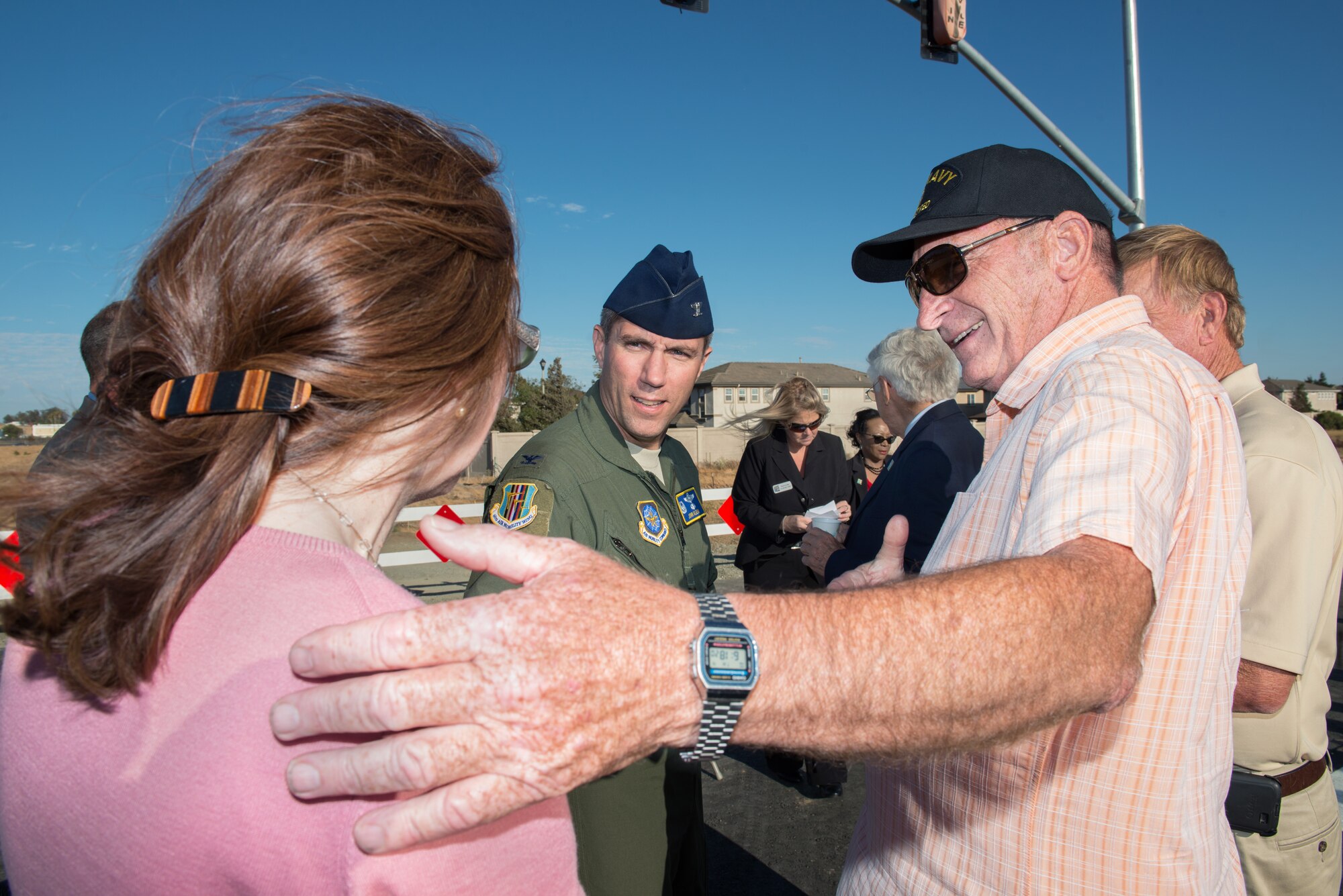 Michael Segala, councilmember for Suisun City, Calif., introduces his wife to U.S. Air Force Col. John Klein, 60th Air Mobility Wing commander, at Travis Air Force Base, before the Peabody Road reopening ceremony in Fairfield, Calif., Aug. 4, 2016. The road was closed for 14-months and finished ten days ahead of schedule. Peabody Road is a major thoroughfare that connects the cities of Vacaville and Fairfield, more than 20,000 vehicles per day use the road and it is also a major artery into Travis Air Force Base for more than 14,000 employees. The construction of the Peabody Road overpass is part of the new Fairfield-Vacaville train station project along the Capitol Corridor. (U.S. Air Force photo by Louis Briscese) 