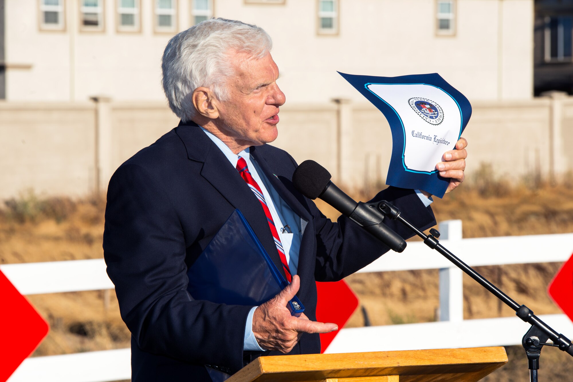 Mayor Harry Price, City of Fairfield, Calif., holds up the certificate of appreciation he received from the California Legislature during the Peabody Road reopening ceremony in Fairfield, Calif., Aug. 4, 2016. The road was closed for 14-months and finished ten days ahead of schedule. Peabody Road is a major thoroughfare that connects the cities of Vacaville and Fairfield, more than 20,000 vehicles per day use the road and it is also a major artery into Travis Air Force Base for more than 14,000 employees. The construction of the Peabody Road overpass is part of the new Fairfield-Vacaville train station project along the Capitol Corridor. (U.S. Air Force photo by Louis Briscese) 