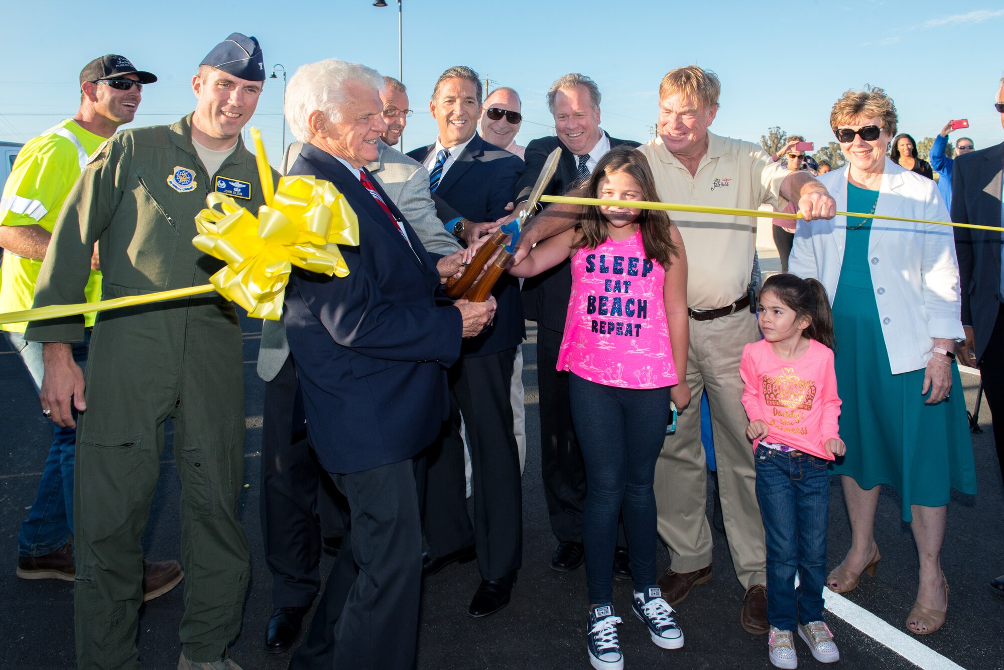 Mayor Harry Price, City of Fairfield, Calif., U.S. Air Force Col. John Klein, 60th Air Mobility Wing commander, at Travis Air Force Base, Calif., and other city officials cut the ribbon officially opening the Peabody Road overpass during the reopening ceremony in Fairfield, Calif., Aug. 4, 2016. The road was closed for 14-months and finished ten days ahead of schedule. Peabody Road is a major thoroughfare that connects the cities of Vacaville and Fairfield, more than 20,000 vehicles per day use the road and it is also a major artery into Travis Air Force Base for more than 14,000 employees. The construction of the Peabody Road overpass is part of the new Fairfield-Vacaville train station project along the Capitol Corridor. (U.S. Air Force photo by Louis Briscese) 