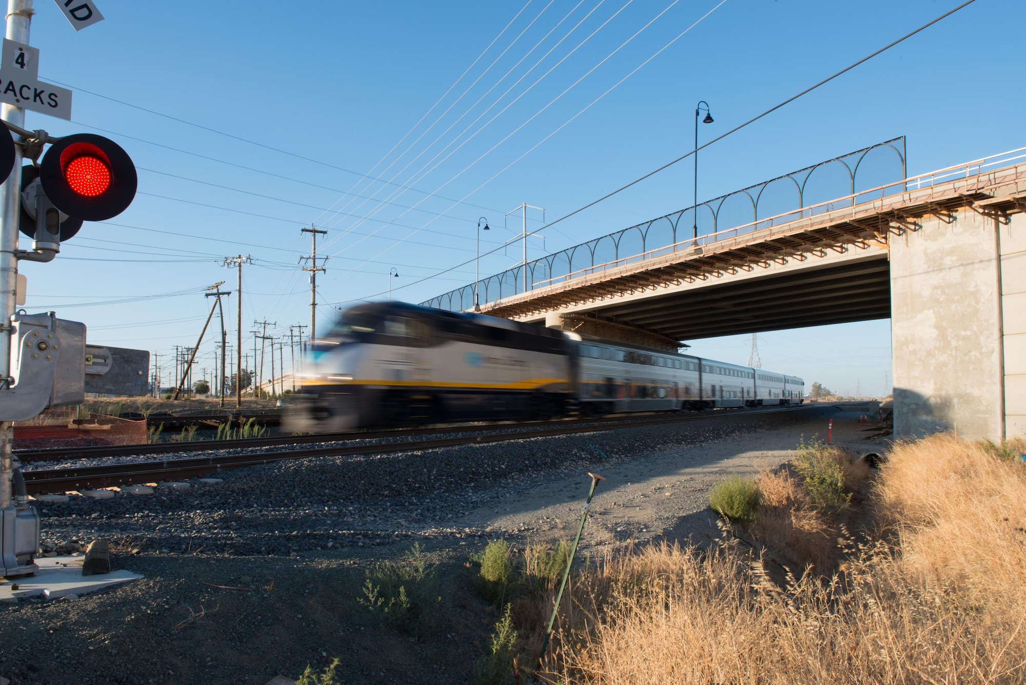 An Amtrak train speeds under the newly constructed Peabody Road overpass after the reopening ceremony in Fairfield, California, Aug. 4, 2016. The road was closed for 14-months and finished ten days ahead of schedule. Peabody Road is a major thoroughfare that connects the cities of Vacaville and Fairfield, more than 20,000 vehicles per day use the road and it is also a major artery into Travis Air Force Base for more than 14,000 employees. The construction of the Peabody Road overpass is part of the new Fairfield-Vacaville train station project along the Capitol Corridor. (U.S. Air Force photo by Louis Briscese) 