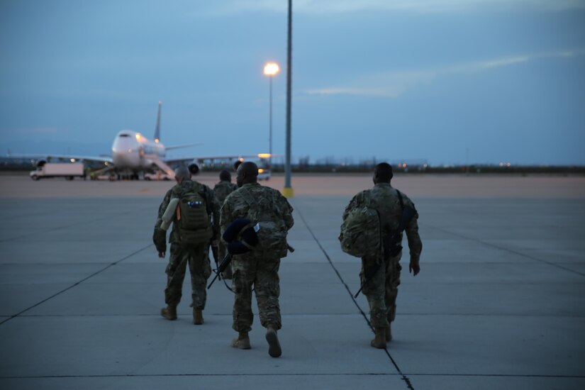 Soldiers assigned to the 176th Engineer Brigade walk form the Silas L. Copeland Arrival/Departure Airfield Control Group to the airplane that will take them to the Middle East July 29.