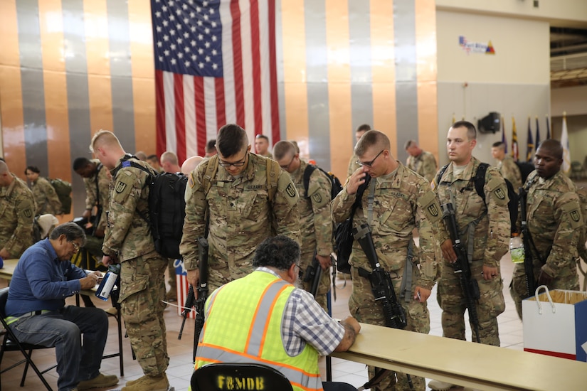 Soldiers assigned to the 389th Engineer Company weigh in for accountability prior to the flight that will take them to the Middle East July 29 at the Silas. L. Copeland Arrival/Departure Airfield Control Group