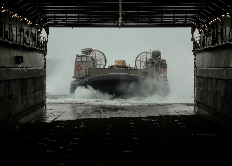 A U.S. Navy Landing Craft Air Cushion pulls into the USS Oak Hill (LSD-51) miles off the Virginia coast Jul. 30, 2016. The LCAC carried Marine Corps Humvees aboard the ship to be used in a static display during Lobster Fest in Rockland, ME, Aug. 3-7, 2016. The Marines and Sailors with Combat Logistics Battalion 8, 2nd Marine Logistics Group, aboard the USS Oak Hill, were in port to participate in the festival and display the expeditionary capabilities of the Navy-Marine Corps team. (U.S. Marine Corps photo by Sgt. Olivia McDonald)