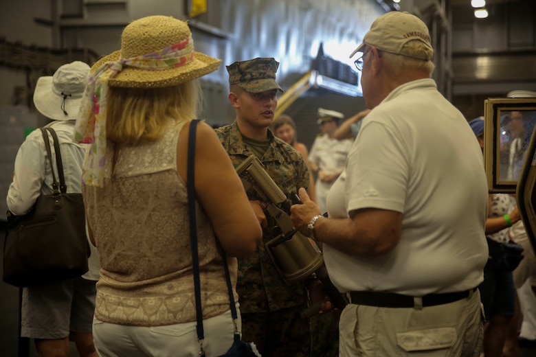 Visitors aboard the USS Oak Hill (LSD-51) learn about the Marine Corps weapon systems and vehicles on display during Lobster Fest in Rockland, ME, Aug. 5, 2016. Marines and sailors with Combat Logistics Battalion 8, 2nd Marine Logistics Group, aboard the USS Oak Hill, were in port Aug. 3-7 to participate in the festival and display the expeditionary capabilities of the Navy-Marine Corps team. (U.S. Marine Corps photo by Sgt. Olivia McDonald)