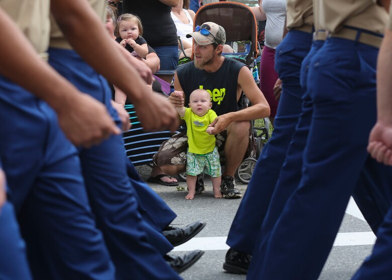 Local residents look on as Marines and sailors march by during the Lobster Fest parade in Rockland, ME, Aug. 6, 2016. The Marines and sailors with Combat Logistics Battalion 8, 2nd Marine Logistics Group, aboard the USS Oak Hill (LSD-51), were in port Aug. 3-7 to participate in the festival and display the expeditionary capabilities of the Navy-Marine Corps team. (U.S. Marine Corps photo by Sgt. Olivia McDonald)