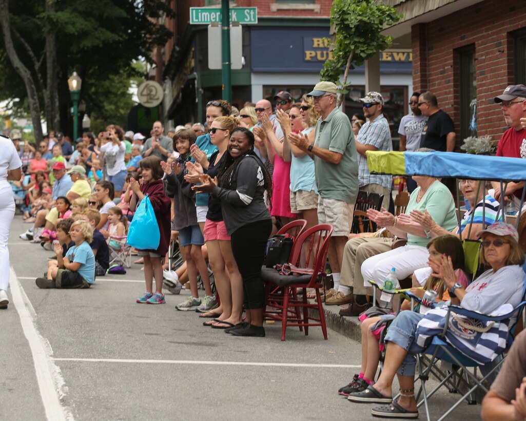 Residents cheer as Marines and Sailors with Combat Logistics Battalion 8, 2nd Marine Logistics Group march down the streets of Rockland, ME during the Lobster Fest parade, Aug. 6, 2016. The Marines and Sailors with the unit aboard the USS Oak Hill (LSD-51) were in port Aug. 3-7 to participate in the festival and display the expeditionary capabilities of the Navy-Marine Corps team. (U.S. Marine Corps photo by Sgt. Olivia McDonald)
